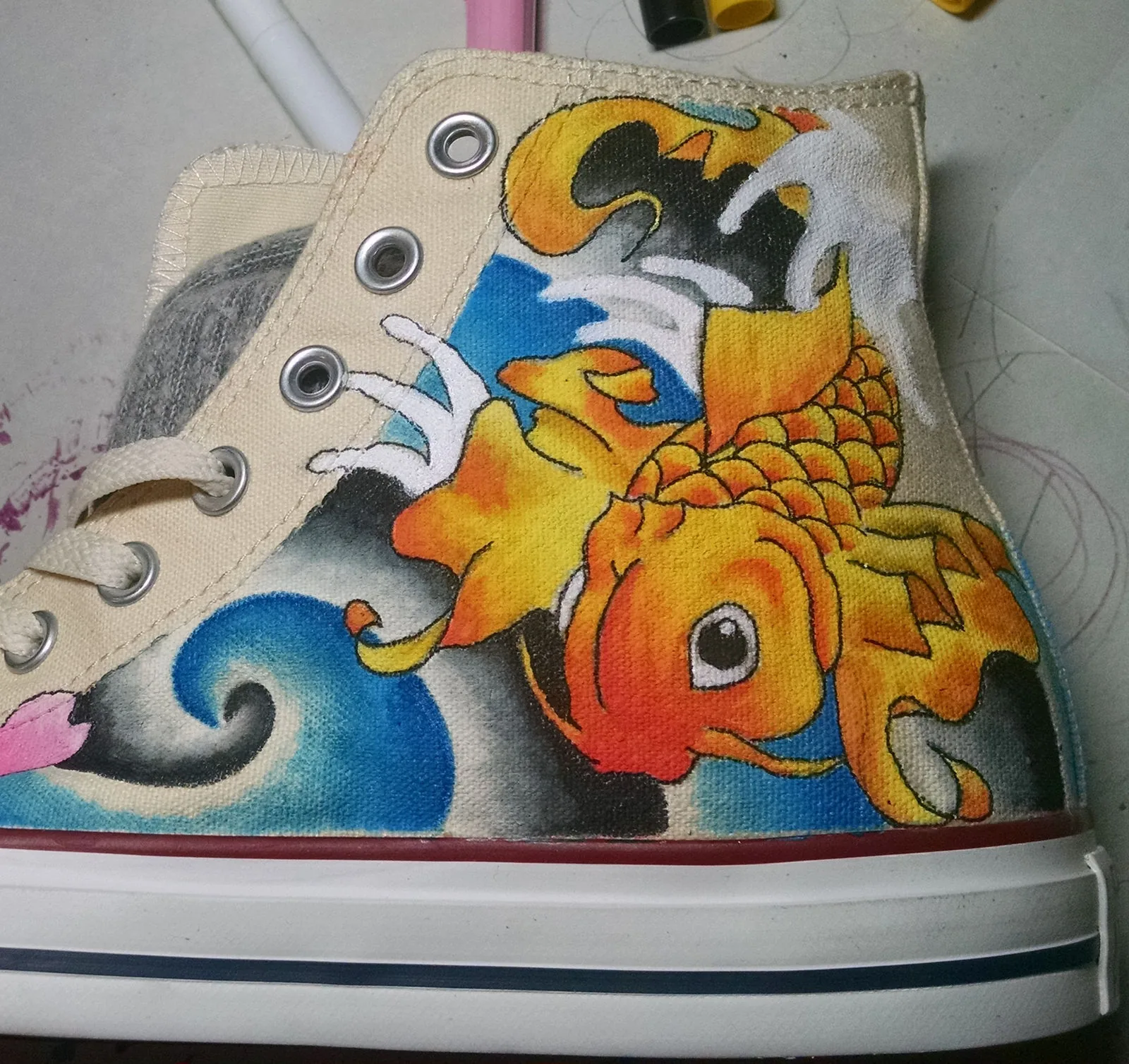 High-top sneaker hand-painted with an orange koi fish and waves