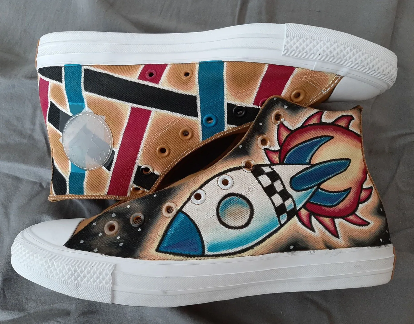 Sneakers painted with a retro rocket and geometric patterns