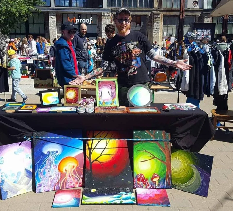 Paintings displayed at an outdoor market stall in Estonia