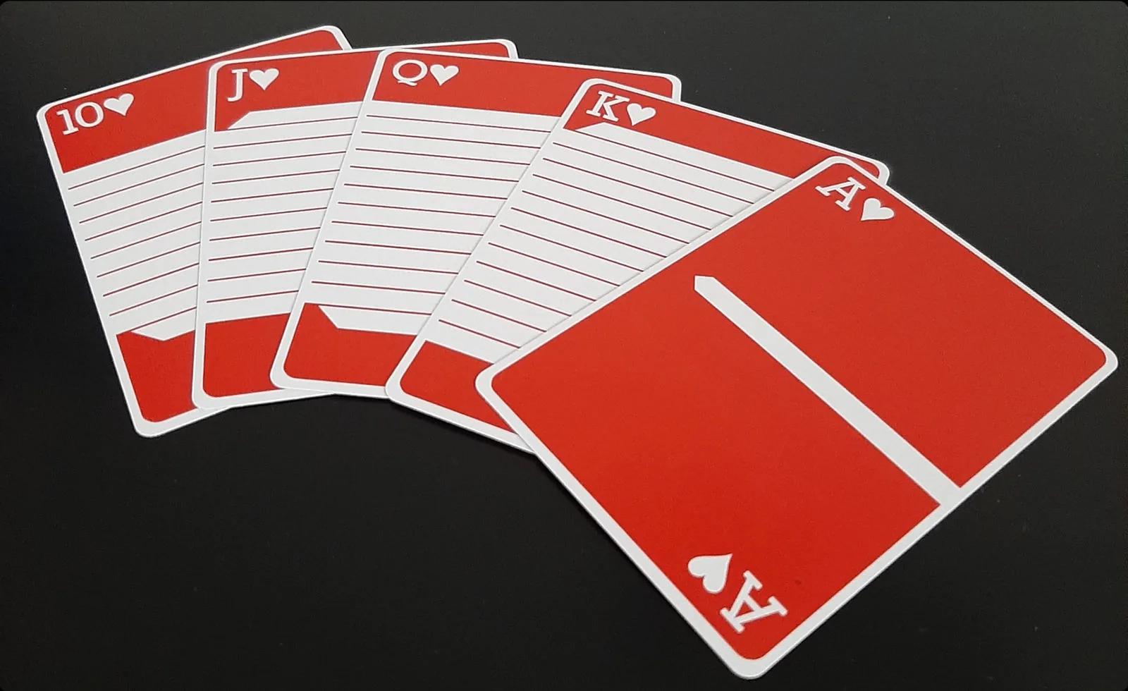 A red royal flush of Pinstripe cards fanned out on a black background