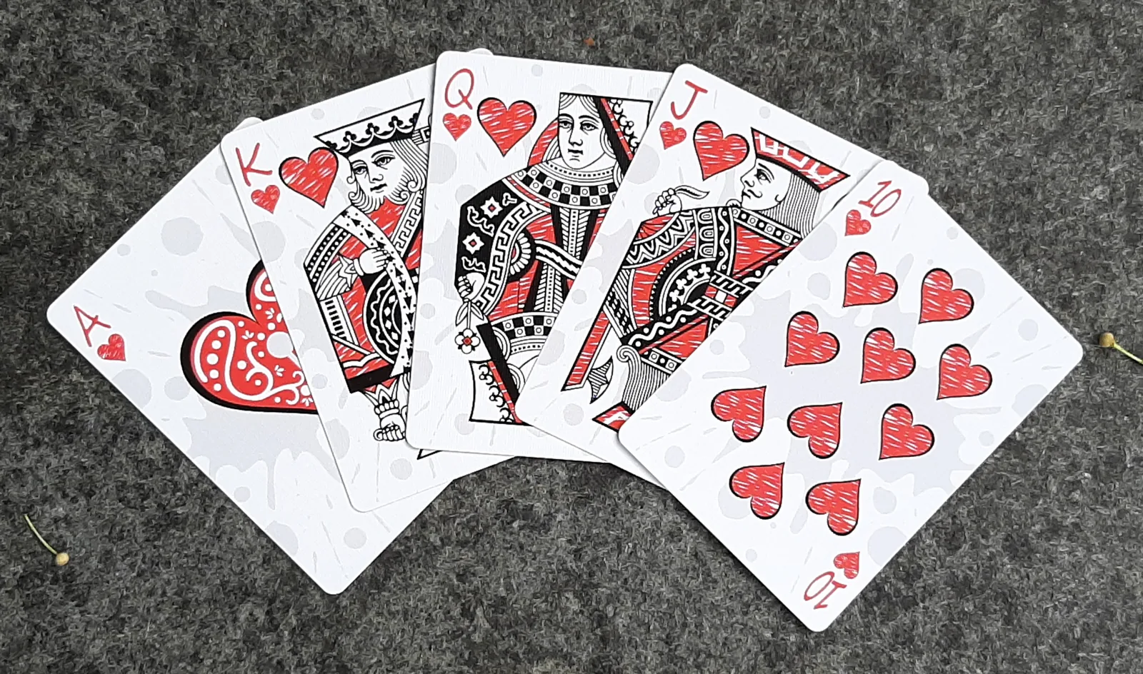 A fan of Inkwell hearts with red and blue pen-drawn court cards