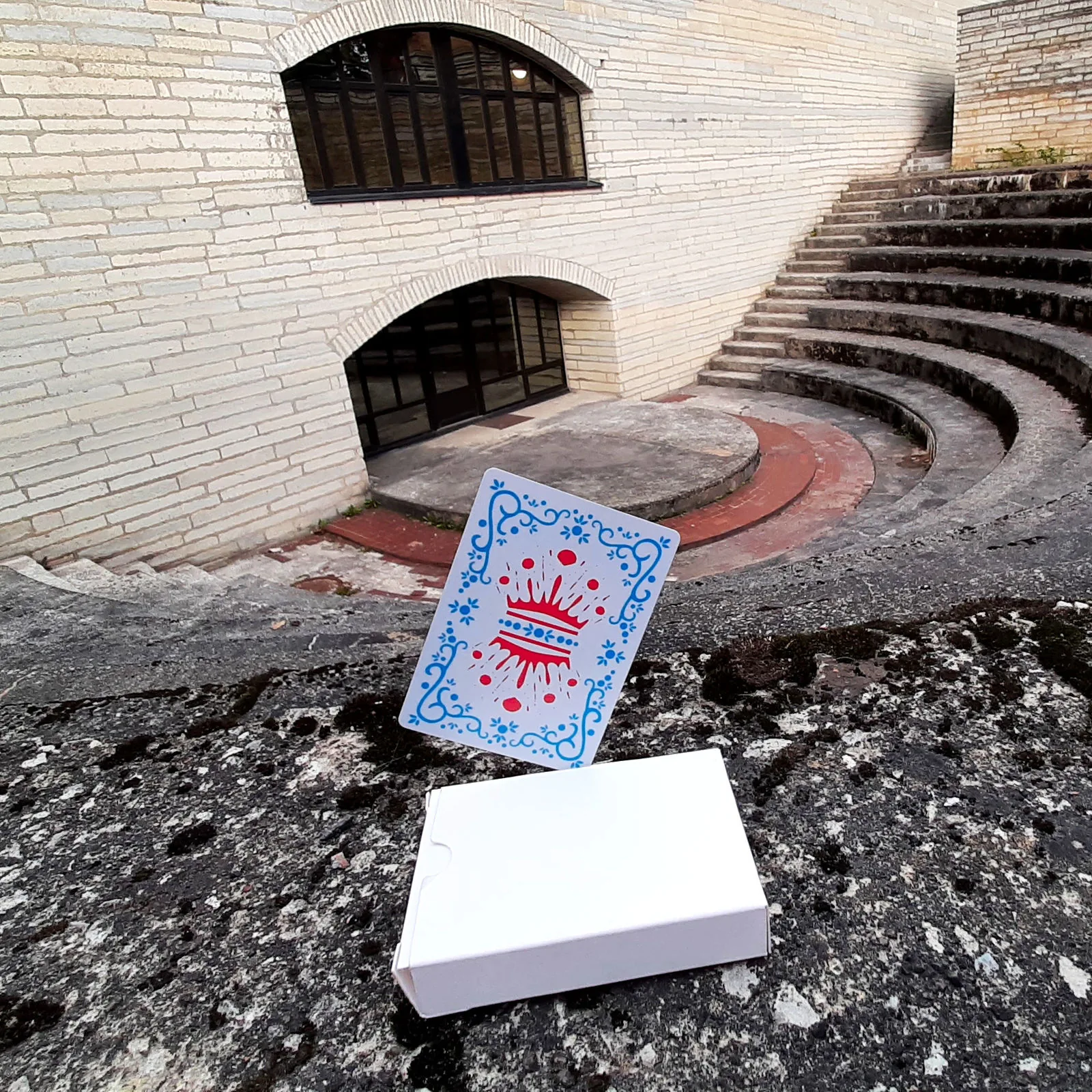 Inkwell card and box in front of a stone amphitheater