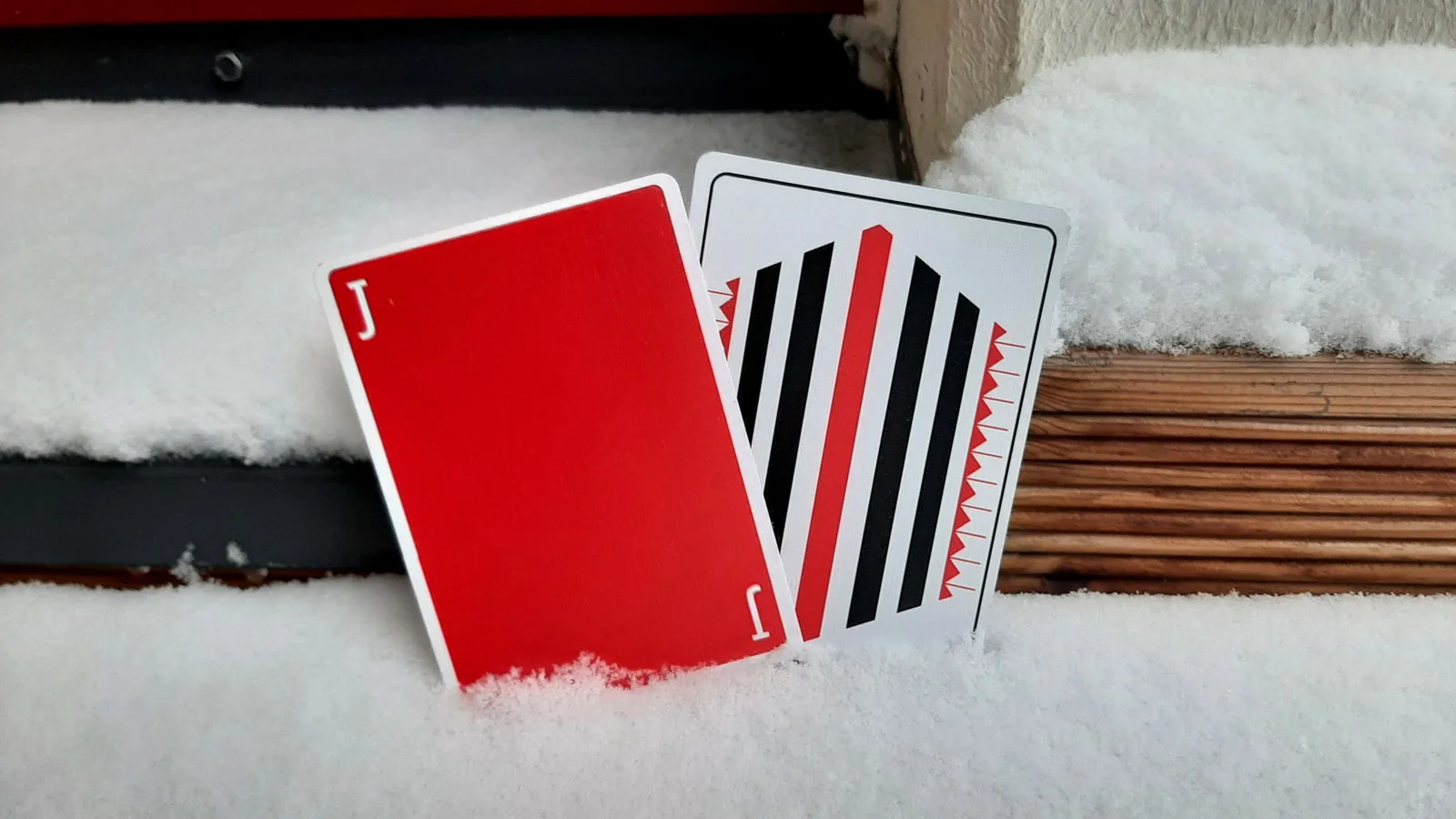 Red and white Pinstripe cards propped up in the snow